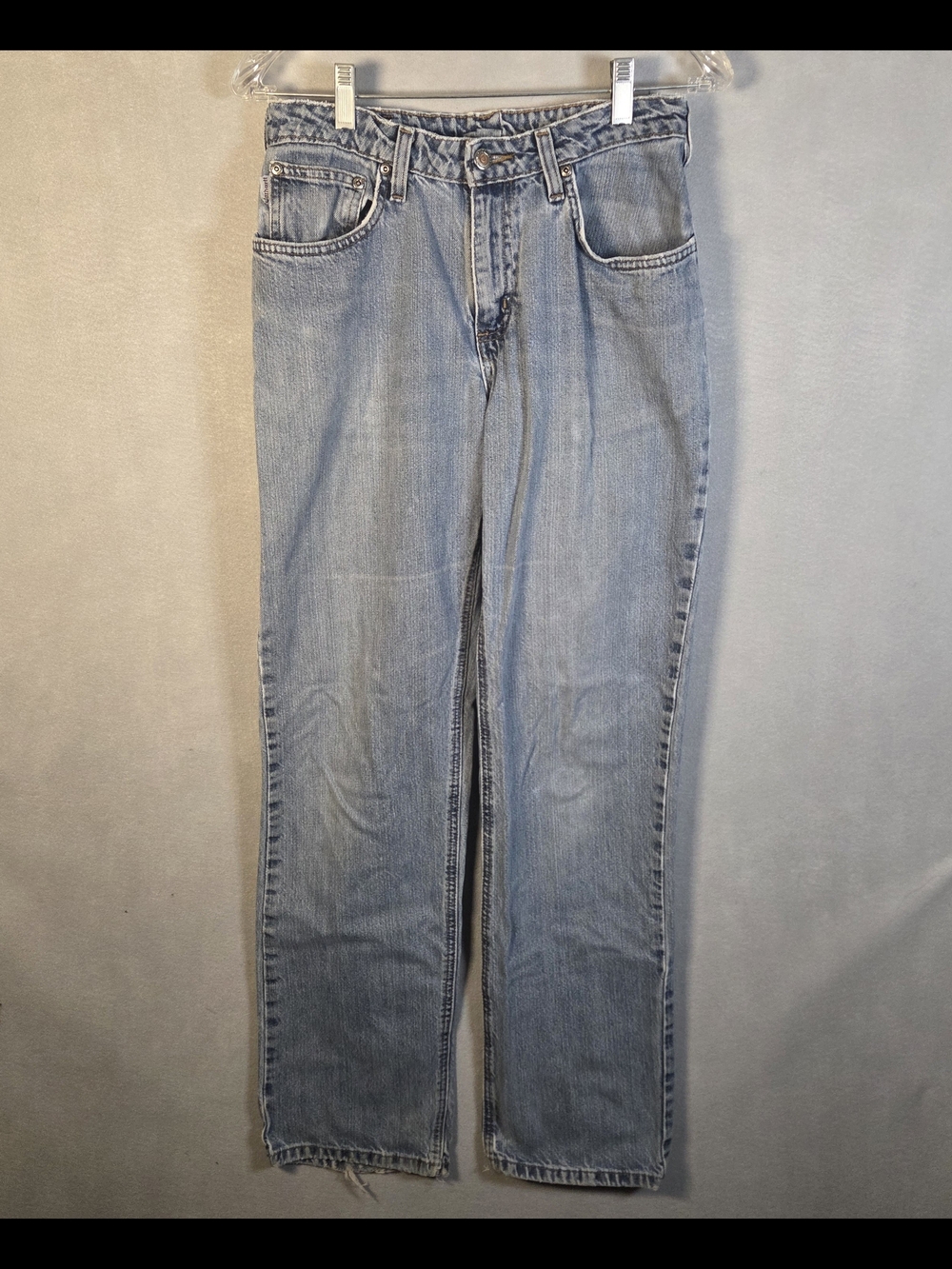 Carhartt jeans. .The denim has signs of wear, fraying at the hem. (S585)